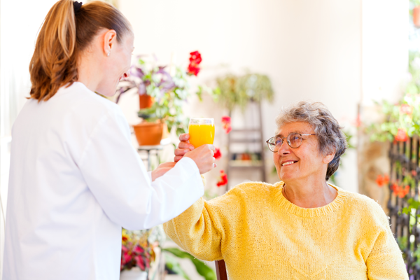 nurse and patient smiling at each other